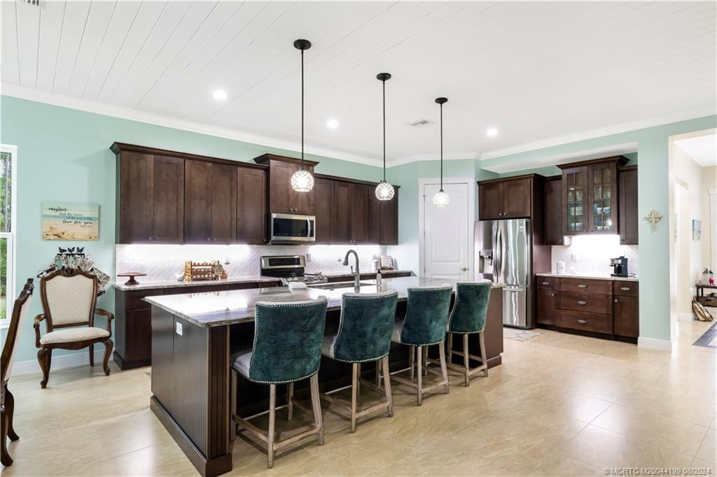 Kitchen with custom wood cabinets, Quartzite Countertops, Marble Backsplash