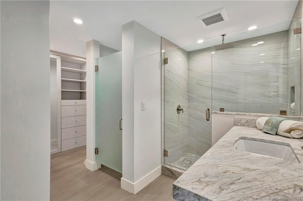 Guest bedroom ensuite bathroom with private water closet and custom closet