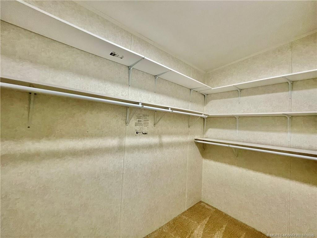 Primary bedroom walk-in closet