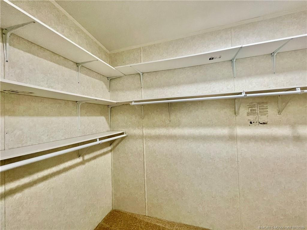 Primary bedroom walk-in closet