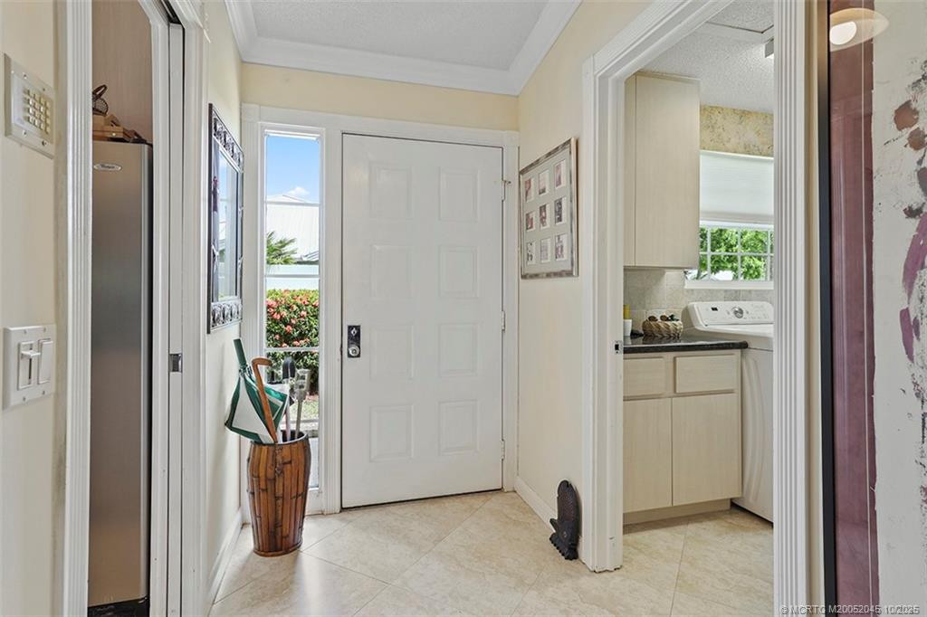 With the kitchen to your right and the laundry room to the left