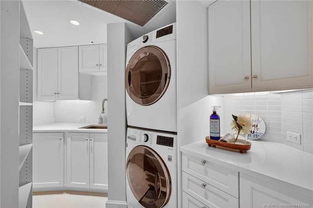 Functional laundry room with sink, folding area, LG steam washer and dryer