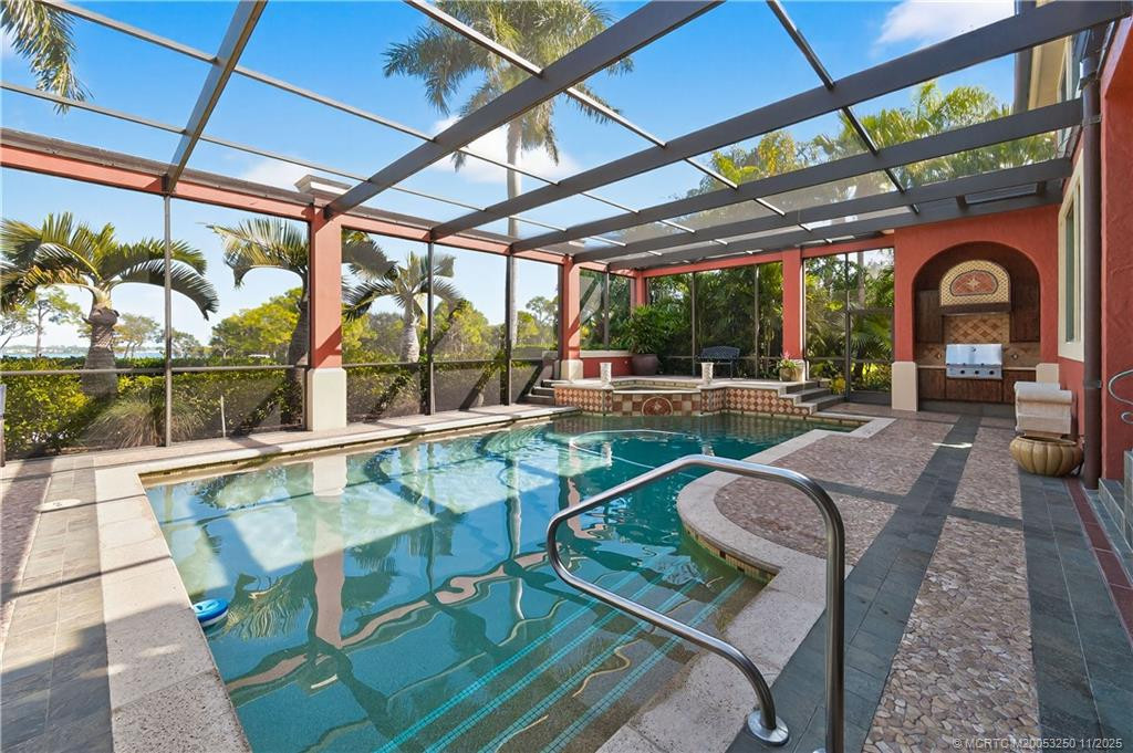 Screen Enclosed Pool with Spa overlooking the mile-wide St. Lucie River