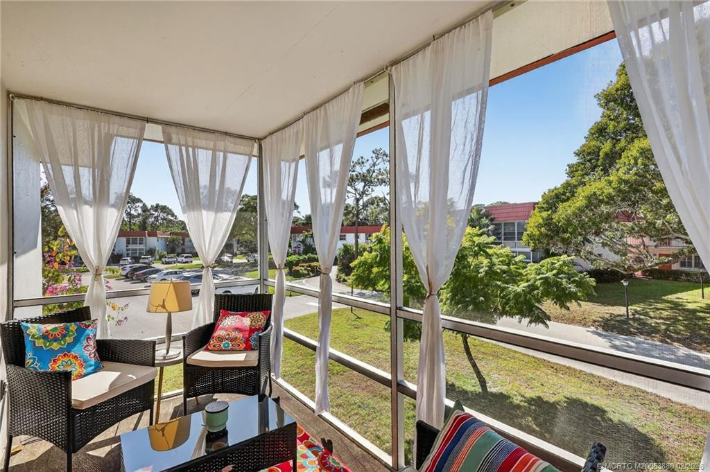 Enjoy the outdoors from this beautiful screened, shaded balcony.