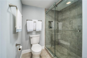 Tile to the ceiling. Lovely glass doors