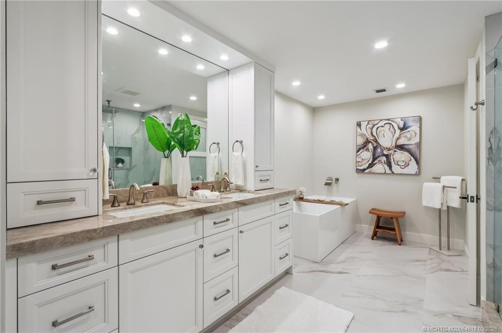 Two sinks and ample storage in this owner's bath
