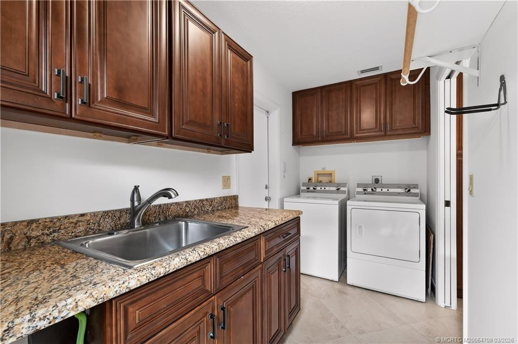 Landry room with sink and door to the outdoors