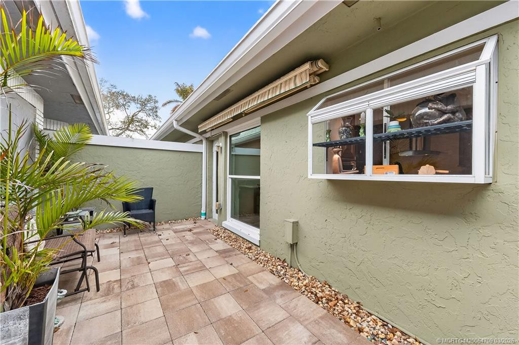 side brick paver area, with electric awning