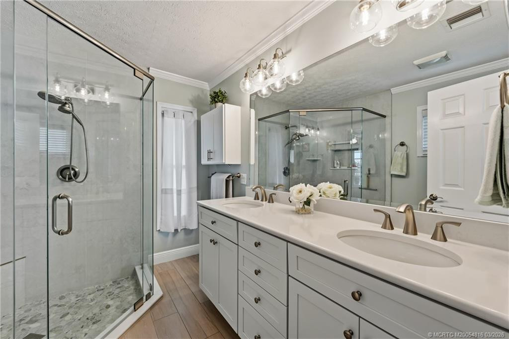 Primary bath with dual sinks and glass enclosed shower
