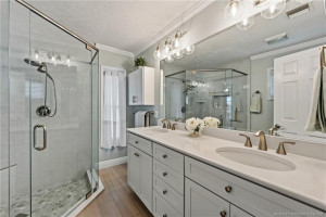 Primary bath with dual sinks and glass enclosed shower