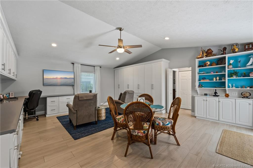 Family room with dining area, workspace and large built-in cabinetry to store crafts, games and supplies.