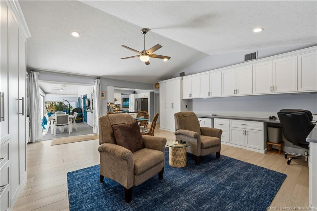 Family room with vaulted ceilings and French doors to pool and covered patio