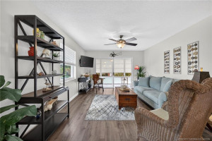 Spacious living with updated luxury vinyl. flooring.