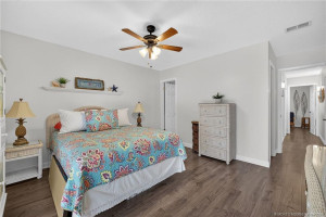 Primary en suite bedroom updated flooring and lighting.