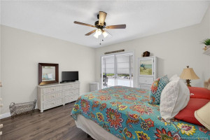 Primary bedroom with sliders out to the enclosed balcony.