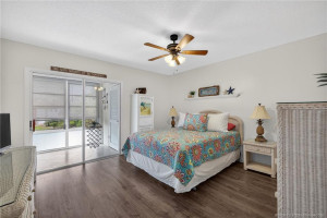 Primary bedroom with sliders to the enclosed lanai.