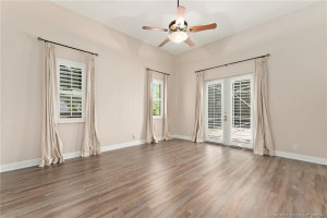 Primary bedroom with french doors to pool area