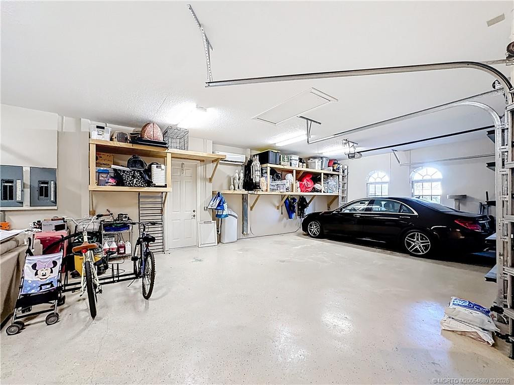 OVERSIZED 3 CAR GARAGE WITH A GOLF CART GARAGE SIDE DOOR TO GET OUT, PULL DOWN STEPS. ALL DOORS HAVE OPENERS. CENTRAL VACUUM. 2 eLECTRIC BOXES.