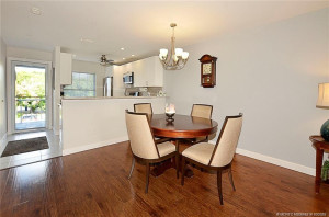 Light and bright dining area flows seamlessly into the updated kitchen featuring white cabinetry, granite countertops, stainless steel appliances, and a convenient breakfast bar that will seat six!