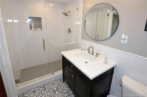 Step into this beautifully renovated bathroom with a sleek glass-enclosed shower, timeless subway tile, and designer finishes that create a fresh, spa-like feel