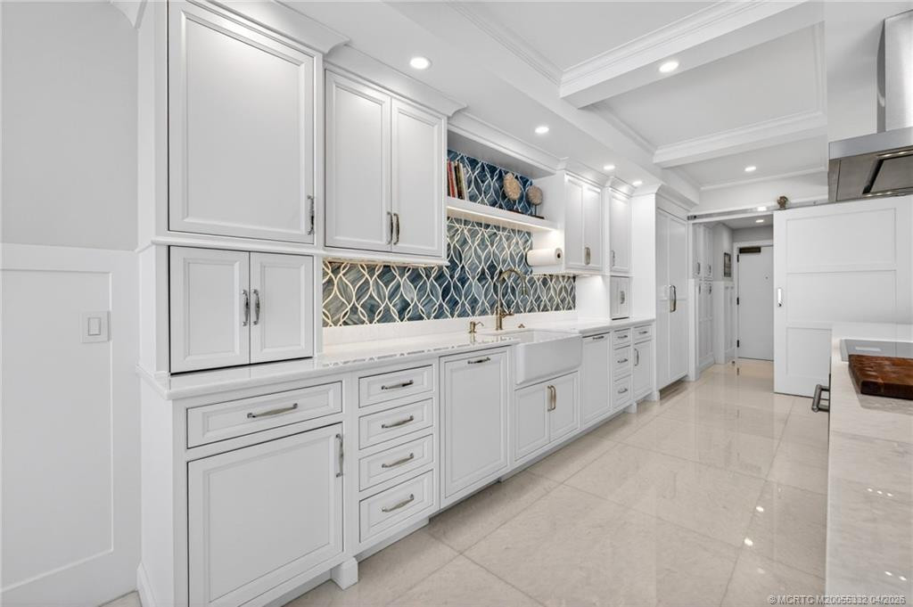 Mouser custom cabinetry adorned with a stunning tiled backsplash
