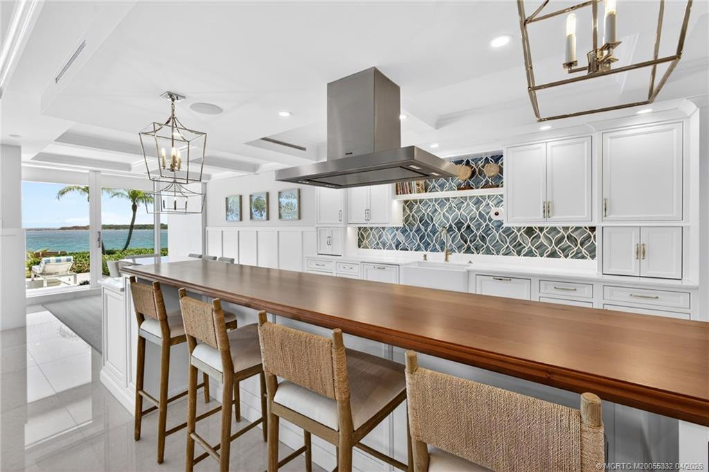 A beautiful bar with a custom cherry countertop offers a space for gathering and casual dining