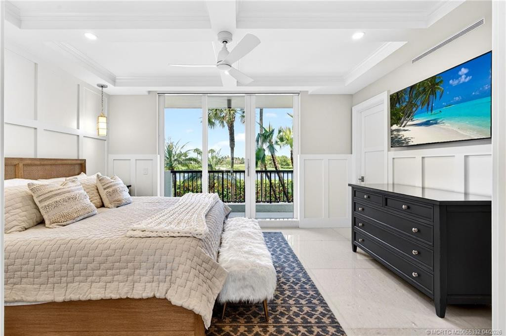 Guest bedroom with ensuite bath and private balcony overlooking the pond