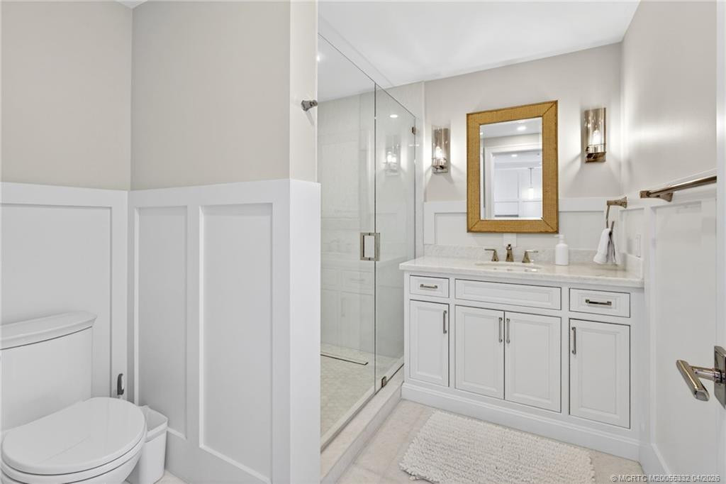 Guest bedroom ensuite bath with gorgeous custom woodwork and marble sink