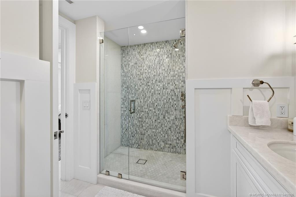 Exquisite tile work in this guest bedroom's ensuite bathroom
