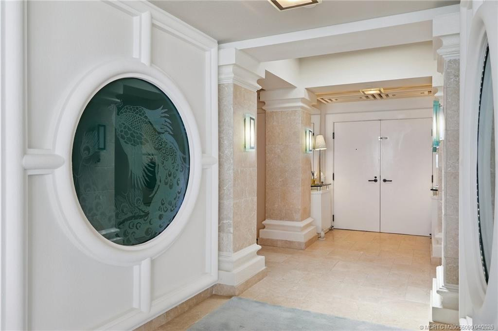 Etched glass peacocks create a striking entry