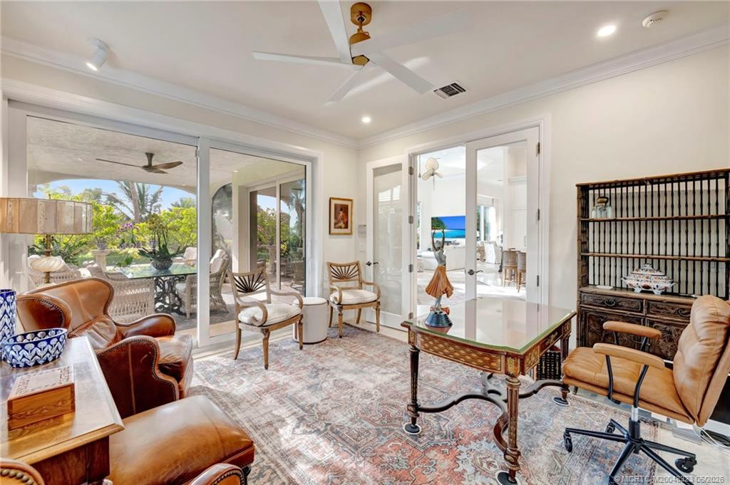 Office or 5th bedroom with access to screened lanai provides views of lush tropical landscaping and the fragrant gardenias