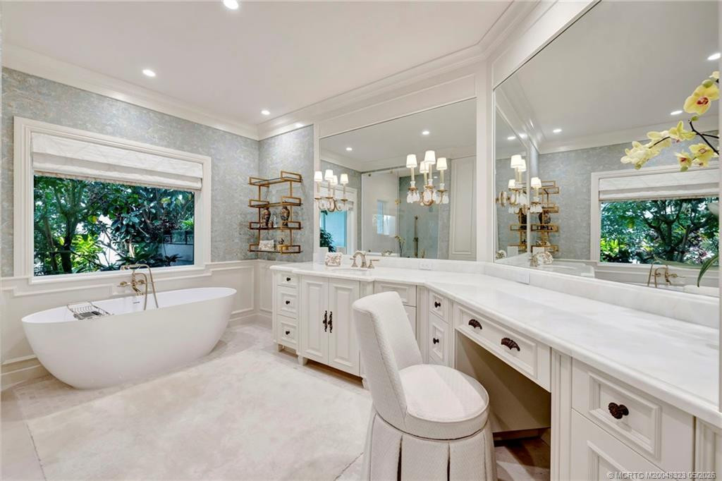 Exquisite primary bath with soaking tub overlooking private gardens