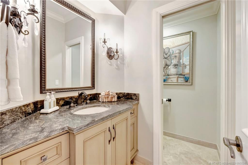Powder room #1 near formal dining room, living room, bar and den