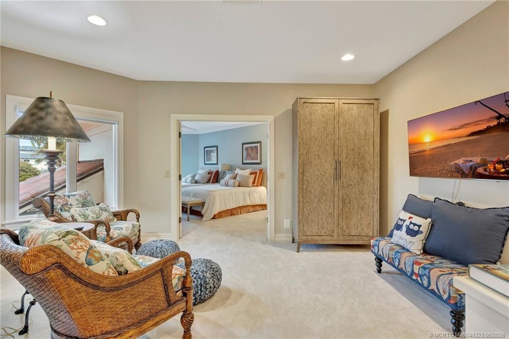 Upper level offers 2 bedrooms, 2 baths, and sitting room with morning bar. A staircase provides easy access to first level entry, creating private guest quarters.