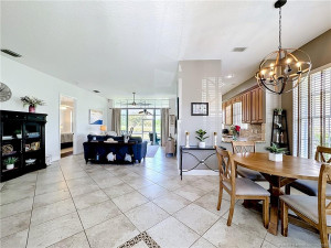 All tiled dining room flows into the Livingroom area and Kitchen, fan, overlooks the screed patio to Waterview and golf course view. High ceilings