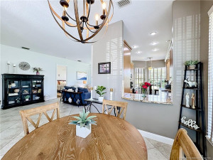 dining room , kitchen with pass through with Livingroom over looks water and golf course.