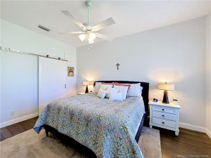 The sliding barn door opens to the primary bathroom and 2 closets. Double sinks and oversized walk in shower