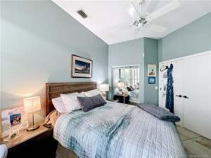 Guest bedroom double entry doors, closet, fan, lots of light and high ceilings Tile floors.