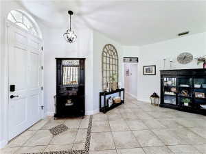 Front door leading into the foyer area off the great room. To the left that goes down to 2 guest bedrooms, guest bathroom , utility room. leads out to the garage area. All floors flow with tile.