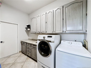 Washer and Dryer are included folding area with a sink, lots of cabinets and to the left of picture a sitting area.
