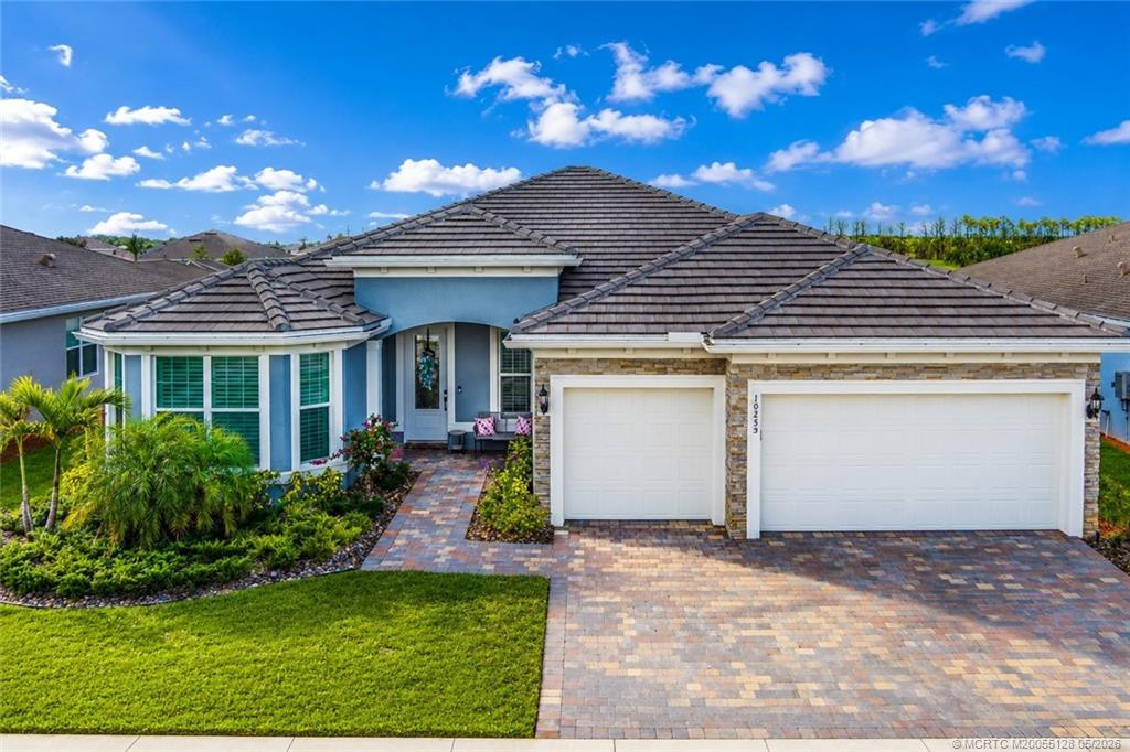 Stunning exterior view of this beautifully designed 3-bedroom, 3-bath residence in Del Webb at Tradition. Featuring elegant stone accents, a paver driveway, lush tropical landscaping, and a spacious 3-car garage, this home offers outstanding curb appeal in one of Tradition’s premier active adult communities. Thoughtfully designed with quality finishes and located close to resort-style amenities, shopping, dining, medical facilities, and major highways.