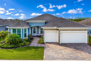 Stunning exterior view of this beautifully designed 3-bedroom, 3-bath residence in Del Webb at Tradition. Featuring elegant stone accents, a paver driveway, lush tropical landscaping, and a spacious 3-car garage, this home offers outstanding curb appeal in one of Tradition’s premier active adult communities. Thoughtfully designed with quality finishes and located close to resort-style amenities, shopping, dining, medical facilities, and major highways.