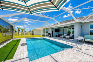 Resort-style screened pool area offers expansive paver decking, covered outdoor living space, and tranquil preserve views for exceptional privacy and relaxation. Designed for entertaining and year-round enjoyment, this impressive outdoor retreat captures the very best of Florida living in Del Webb at Tradition.