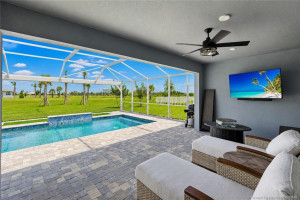 Expansive covered lanai provides the perfect setting for outdoor entertaining and relaxation, overlooking the screened pool and peaceful preserve views. Featuring spacious paver patio areas, ceiling fan, and ample room for lounging and dining, this outdoor living space is designed for year-round Florida enjoyment.