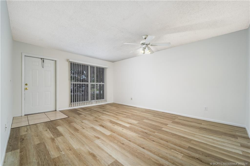 Bright living room with plenty of wall space and new flooring.