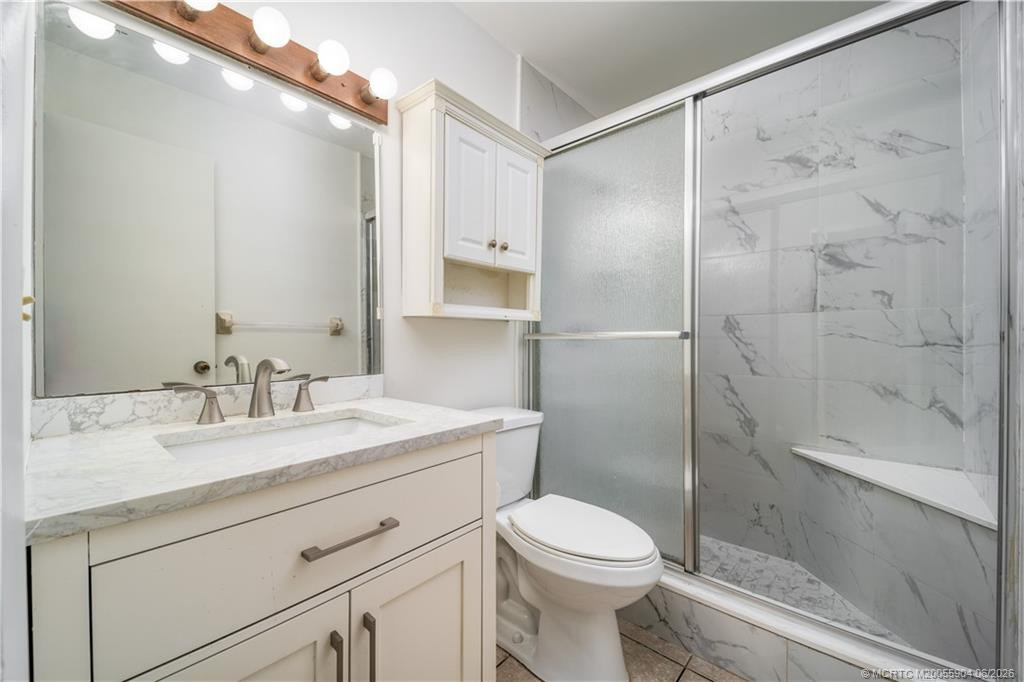 Updated primary bathroom with all new shower, vanity and fixtures.