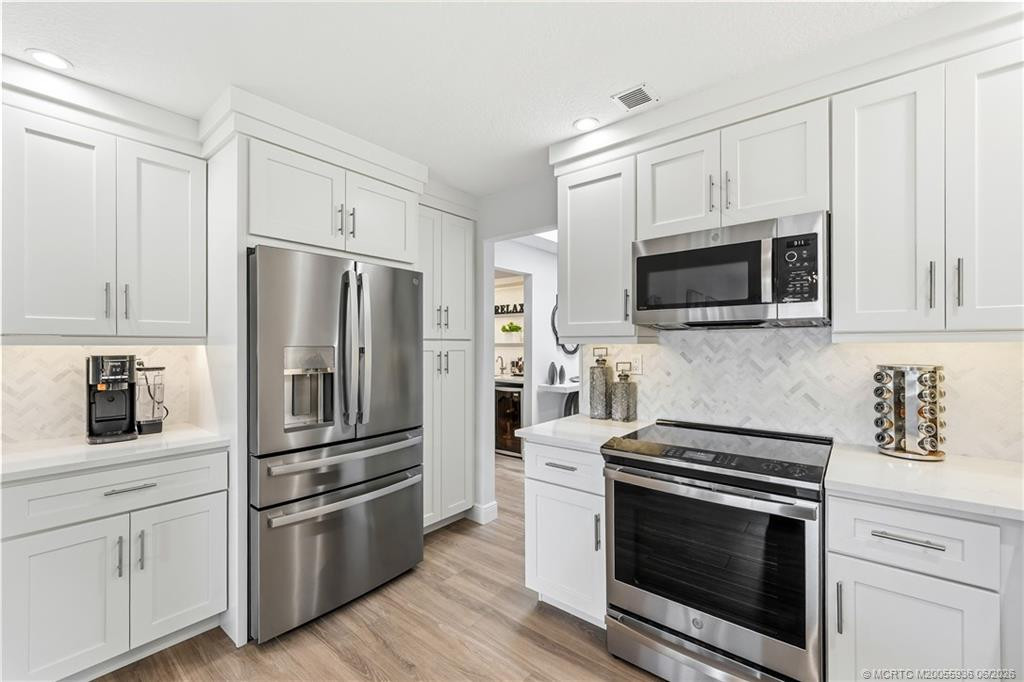 Kitchen with quartz counters and soft close cabinetry.
