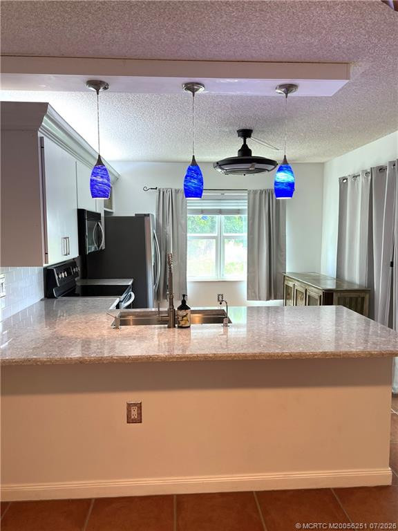 Renovated Kitchen with Quartz Counters at 3505 SW Sunset Trace Circle, Palm City