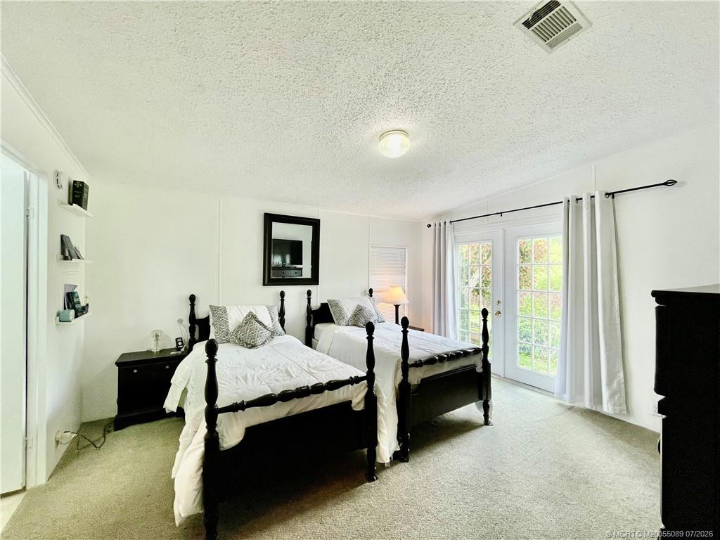 French doors offer a view of nature & birds.
