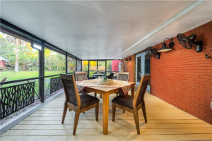 Tranquil screened porch overlooks yard.